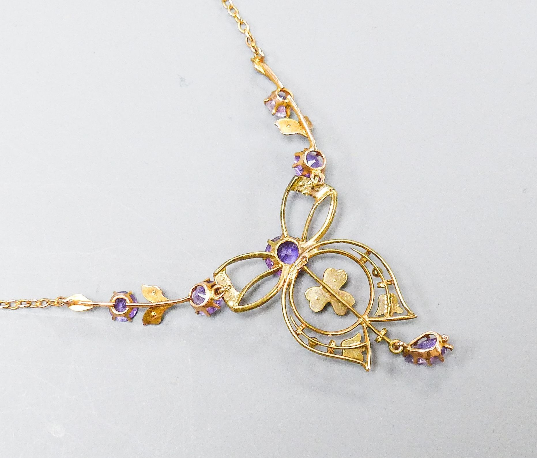 An Edwardian 9ct, amethyst and seed pearl set drop pendant necklace, 44cm